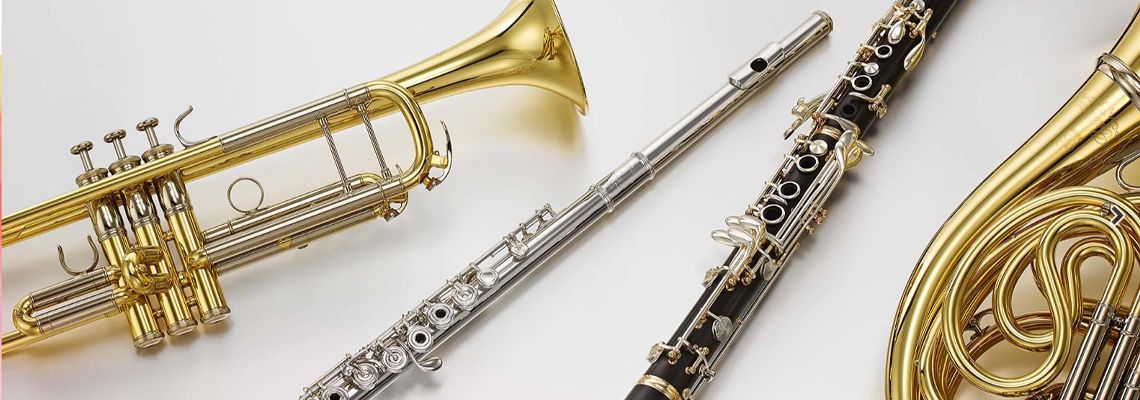 Image of a Trumpet, Flute, Clarinet and a Tuba on a white background