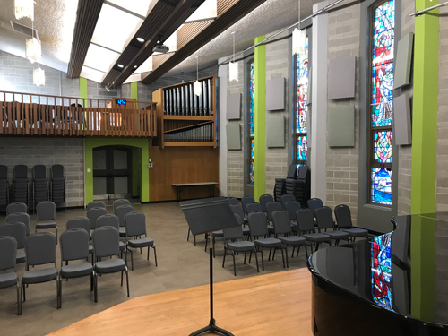 Photo of Wood Hall taken from the stage showing the windows and seating