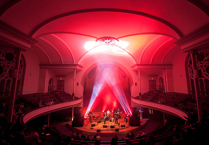 Rock concert with red lighting in Alix Goolden Performance Hall