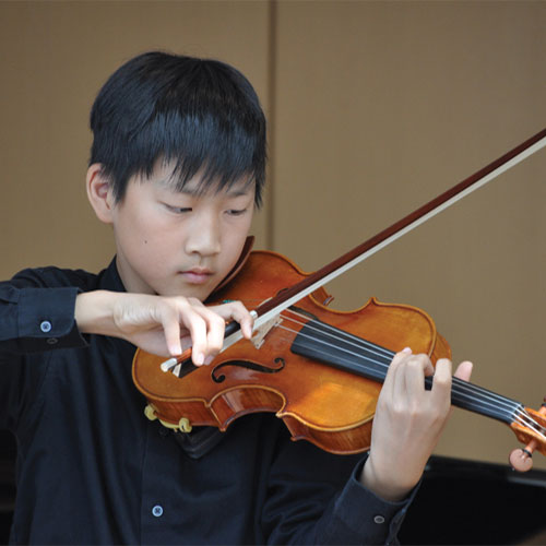 Young male Collegium student playing violin 500px