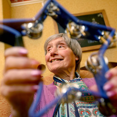 Elderly woman playing star-shaped tambourine 