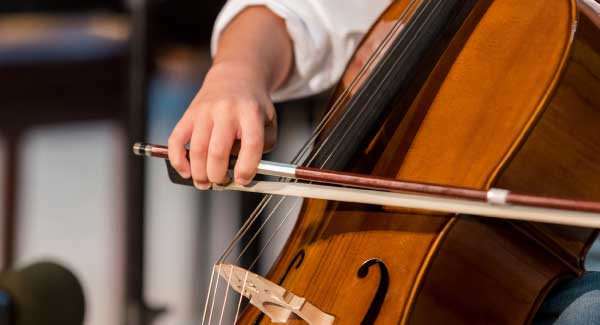 Person playing cello 325x600px